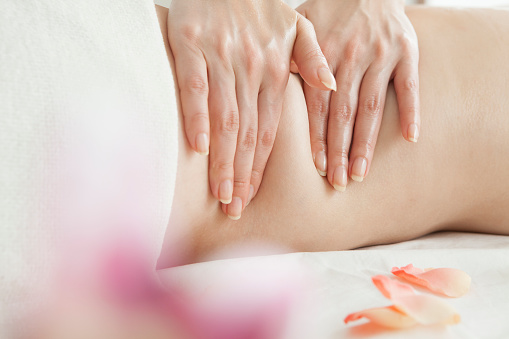 Position of hands and fingers at lymphatic drainage massage of a female body